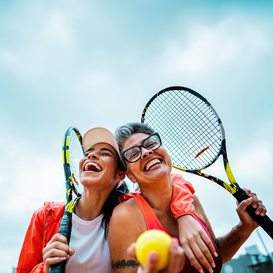happy women playing tennis