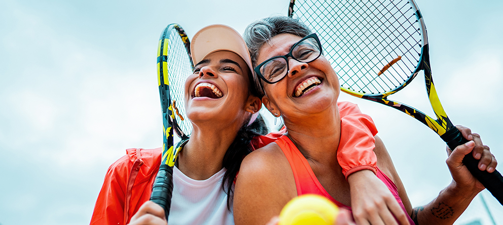 happy women playing tennis