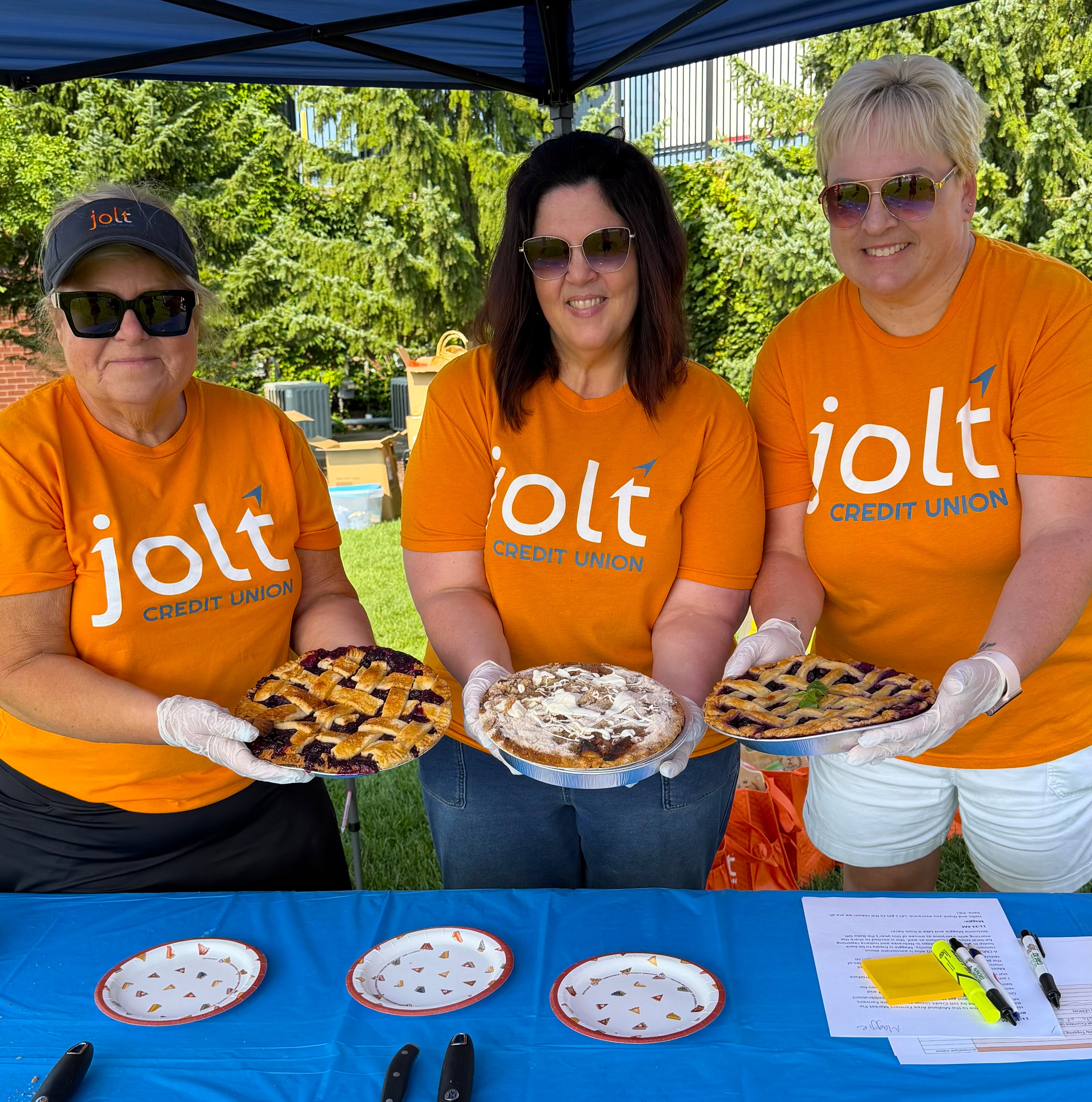 Jolt employees posing at the annual Pie Bake-Off at the Midland Area Farmers Market
