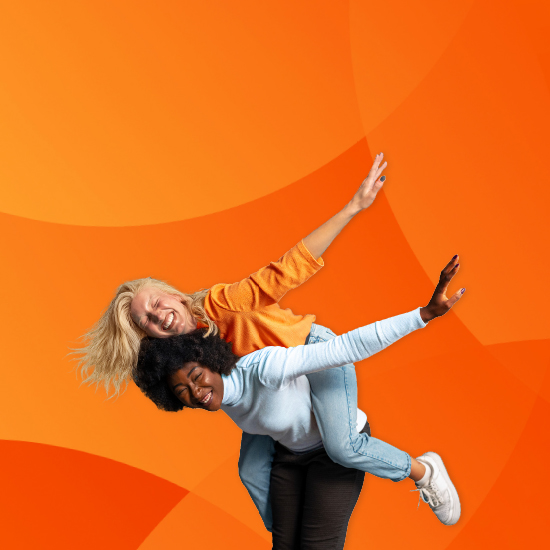 two girls having fun, one holding other on back