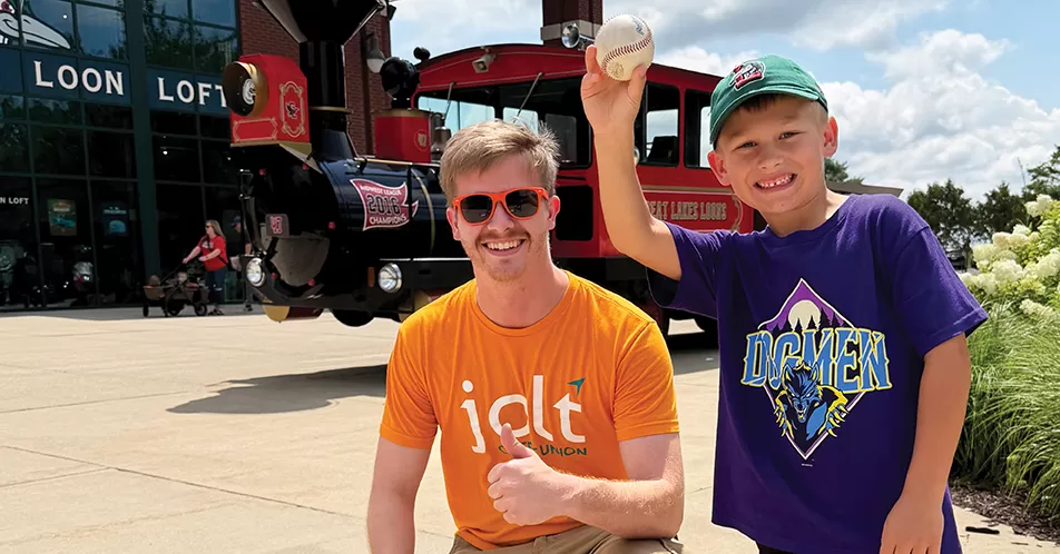 Jolt employee in front of the Dow Diamond 