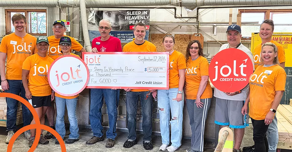 Jolt Credit Union employees presenting a check and volunteering at Sleep in Heavenly Peace.