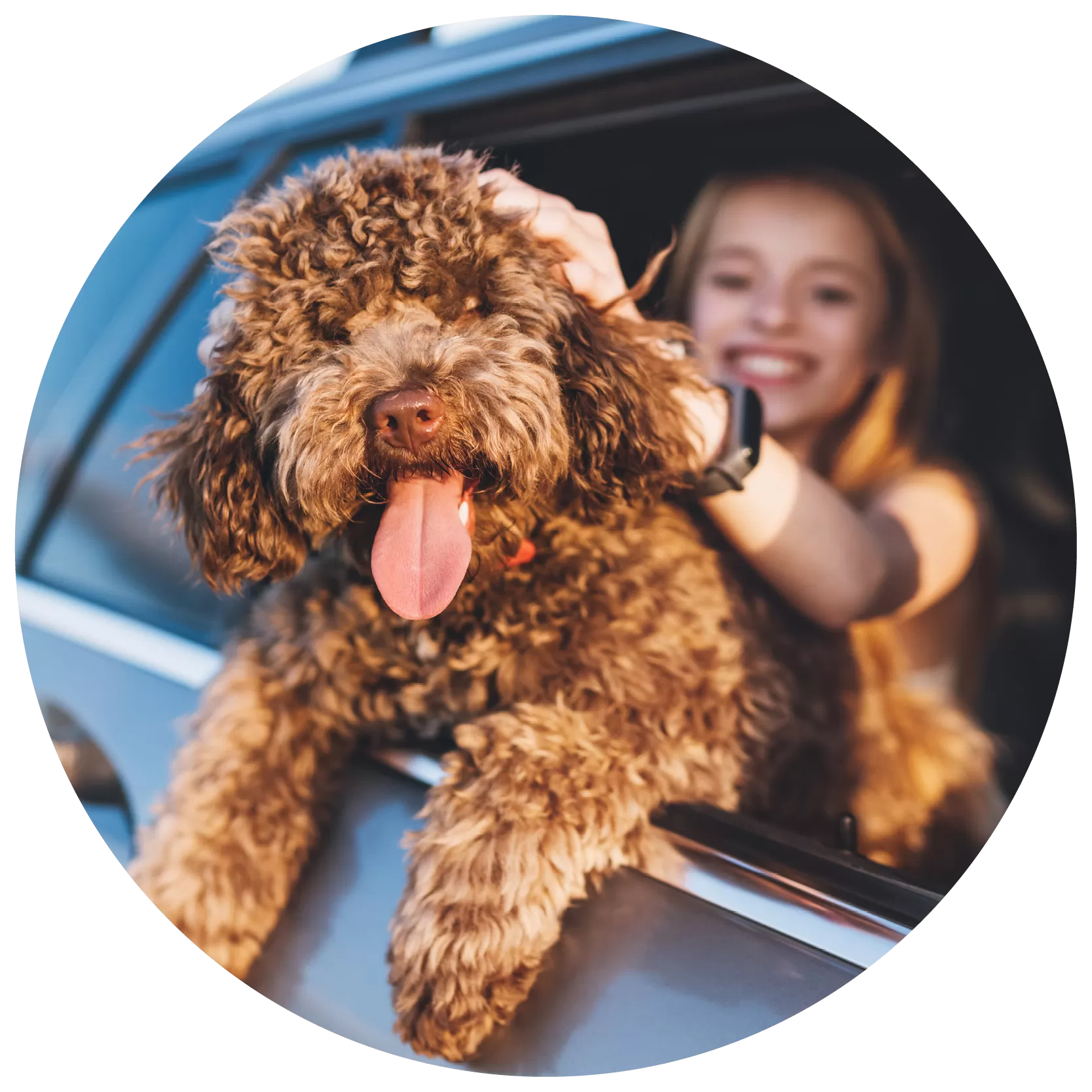 girl and dog hanging out car window